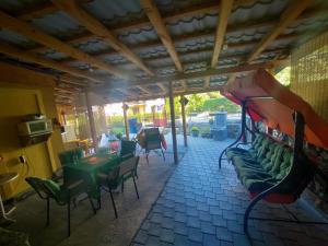 a living room with green chairs and a couch at Dedovina in Soko Banja