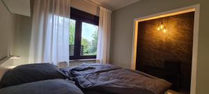 a bedroom with a bed in front of a window at Etappenziel in Rengsdorf