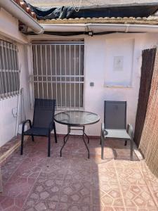 a patio with a table and two chairs at Antique villa in Guardamar del Segura