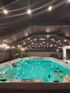 a large swimming pool with lights on top of it at Villa Summerfield Swim Spa in Summerfield