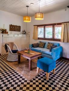 a living room with a blue couch and a table at Quinta Las Marías - Domingos Check out 17 hs in Tigre +32 photos