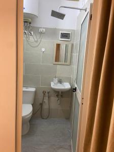 a bathroom with a toilet and a sink at The Two Princesses in Shirokë +43 photos