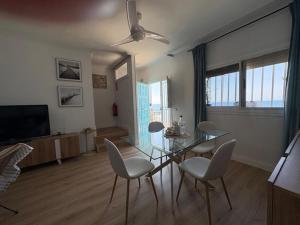 a living room with a glass table and chairs at Ikigai Home in La Rábita