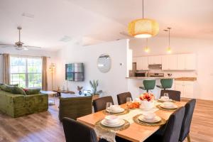 a dining room and living room with a table and chairs at Villa Summerfield Swim Spa in Summerfield