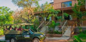 a green jeep parked in front of a building at Nandina Self Catering in Hazyview