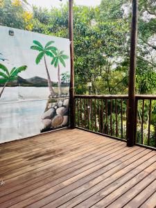 a wooden deck with a mural of a palm tree at Nandina Self Catering in Hazyview +43 photos