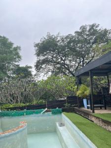 a swimming pool in a yard with a pavilion at Nandina Self Catering in Hazyview