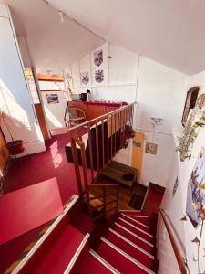 a staircase in a building with red floors and red steps at PAKARI Wasi in Cusco
