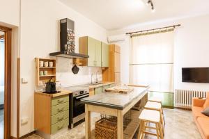 a kitchen with a table and a stove at Residenza Subasio Assisi in Rivotorto