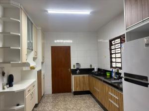 a kitchen with a white refrigerator and a brown door at Chacara el Angel in Socorro