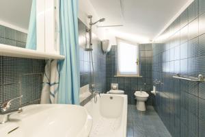 a bathroom with a white tub and a toilet at Residenza Subasio Assisi in Rivotorto +32 photos