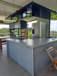 a large kitchen with a large counter top in a room at Casa Luar da Sereia - Itacaré in Itacaré