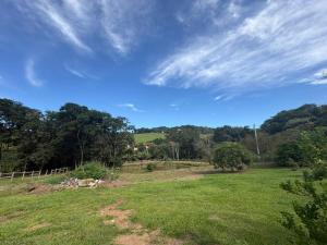 a field with a fence and trees in the background at Chacara el Angel in Socorro
