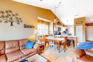 a living room with a couch and a table at Woodpecker's Tree in Branson