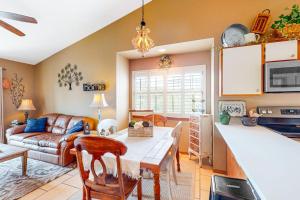 a kitchen and living room with a table and a couch at Woodpecker's Tree in Branson