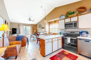 a kitchen and living room with a couch and a table at Woodpecker's Tree in Branson