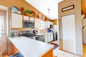 a kitchen with a white counter top and a refrigerator at Woodpecker's Tree in Branson