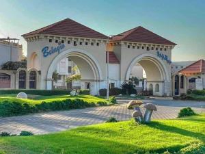 a building with mushrooms in the grass at Chalet in Belagio Ain Sokhna in Ain Sokhna