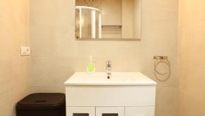a bathroom with a white sink and a mirror at Sleeping portomarin 1 in Portomarin