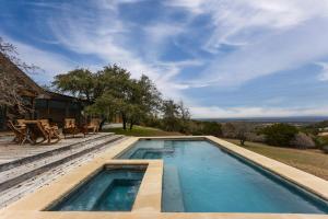 a swimming pool in front of a house at Pool, Porch & Stunning Views: Spacious Texas Home! in Glen Rose