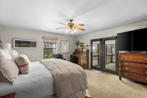 a bedroom with a bed and a ceiling fan at Pool, Porch & Stunning Views: Spacious Texas Home! in Glen Rose