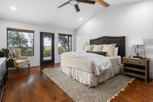 a bedroom with a bed and a ceiling fan at Pool, Porch & Stunning Views: Spacious Texas Home! in Glen Rose +35 photos