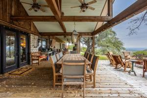 an outdoor patio with a table and chairs at Pool, Porch & Stunning Views: Spacious Texas Home! in Glen Rose