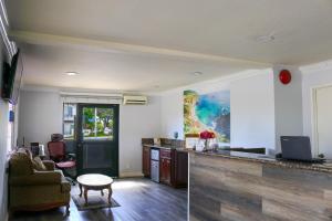 a kitchen and living room with a counter and a table at Orange Tustin Inn in Orange in Orange