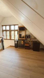an attic room with a kitchen with an attic at Domaine Taïga - Parc animalier en forêt in Sainte-Agathe-des-Monts +25 photos