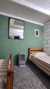 a room with two twin beds and a mirror at BelDaMar in Capilla del Monte