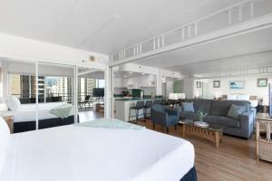 a hotel room with a bed and a living room at Ilikai Tower 1538 condo in Honolulu