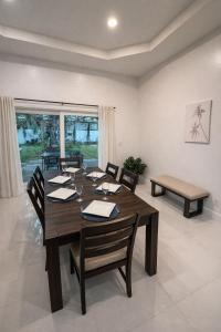 a dining room with a wooden table and chairs at Peaceful Inn at Deerfield Beach Boca Raton in Deerfield Beach