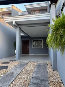 a house with a walkway leading to a door at Casa Privativa Prox Expoville e Centro Com 2 Suítes in Joinville