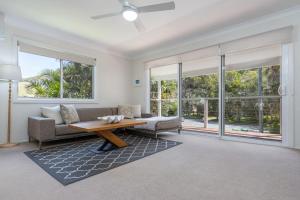 a living room with a couch and a table at Boo's Place in Blueys Beach