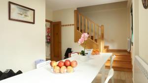 a white table with a vase of fruit on it at Sleeping portomarin 1 in Portomarin +31 photos
