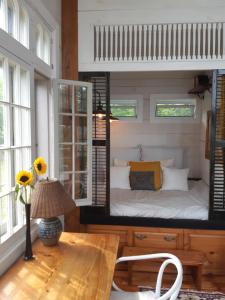 a room with a bed and a table and a mirror at Longview Spectacular Forest Views on 88 Acres in Westport +27 photos