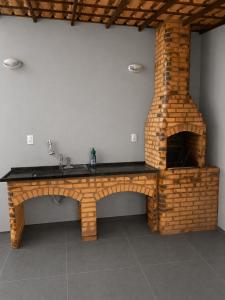 a stone counter with a fireplace in a room at Heyco camping e hospedaria in Cabo Frio