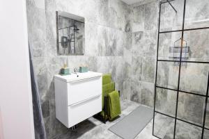 a bathroom with a sink and a shower at The Wheelhouse, Ballycastle in Ballycastle