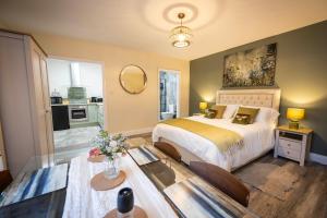 a bedroom with a large bed and a table at The Wheelhouse, Ballycastle in Ballycastle