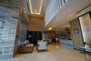 a lobby of a hotel with couches and chairs at Hills HOTEL - فندق هيلز in Al Khobar