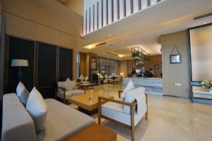 a living room with couches and chairs and a table at Hills HOTEL - فندق هيلز in Al Khobar