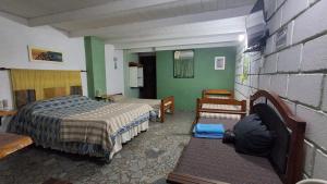 a bedroom with two beds and green walls at BelDaMar in Capilla del Monte