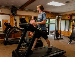 a man and woman on a treadmill in a gym at Indian Head Resort in Lincoln +8 photos