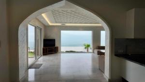 an archway in a room with a view of the ocean at Villa Beni Mejmel avec vue exceptionnelle in Tangier