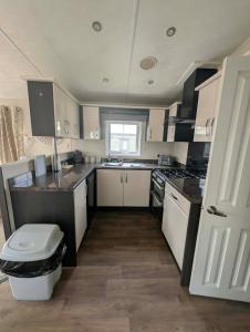 a kitchen with white cabinets and a stove top oven at J&J Retreat in Morpeth