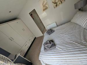 a small bedroom with a bed and a dresser at J&J Retreat in Morpeth