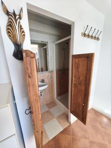 a bathroom with a zebra head on the wall at Beach house in Rincón de la Victoria +16 photos