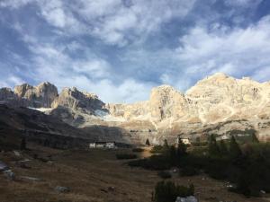 a view of a mountain range with houses in a field at Il Respiro del Brenta in San Lorenzo in Banale