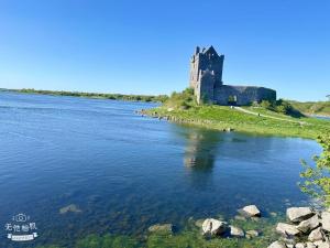 a castle on an island in the middle of a river at Cove Guest Accommodation in Kinvara