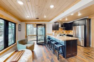 a kitchen with a large island in a house at River House in North Creek